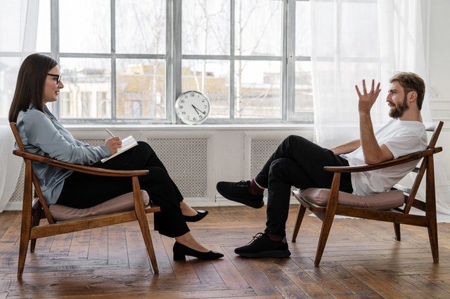 A patient with his therapist participating in individual therapy