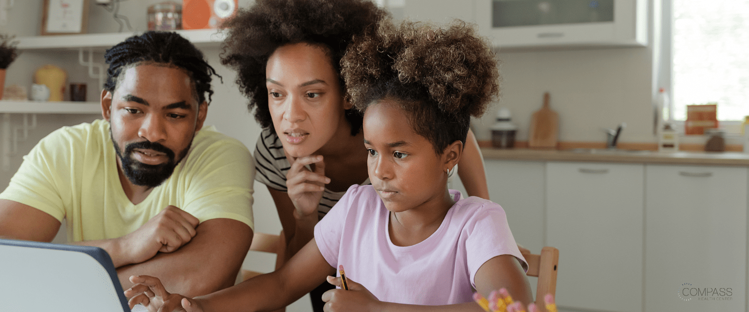 Parents with their child reading about possible mental health care solutions