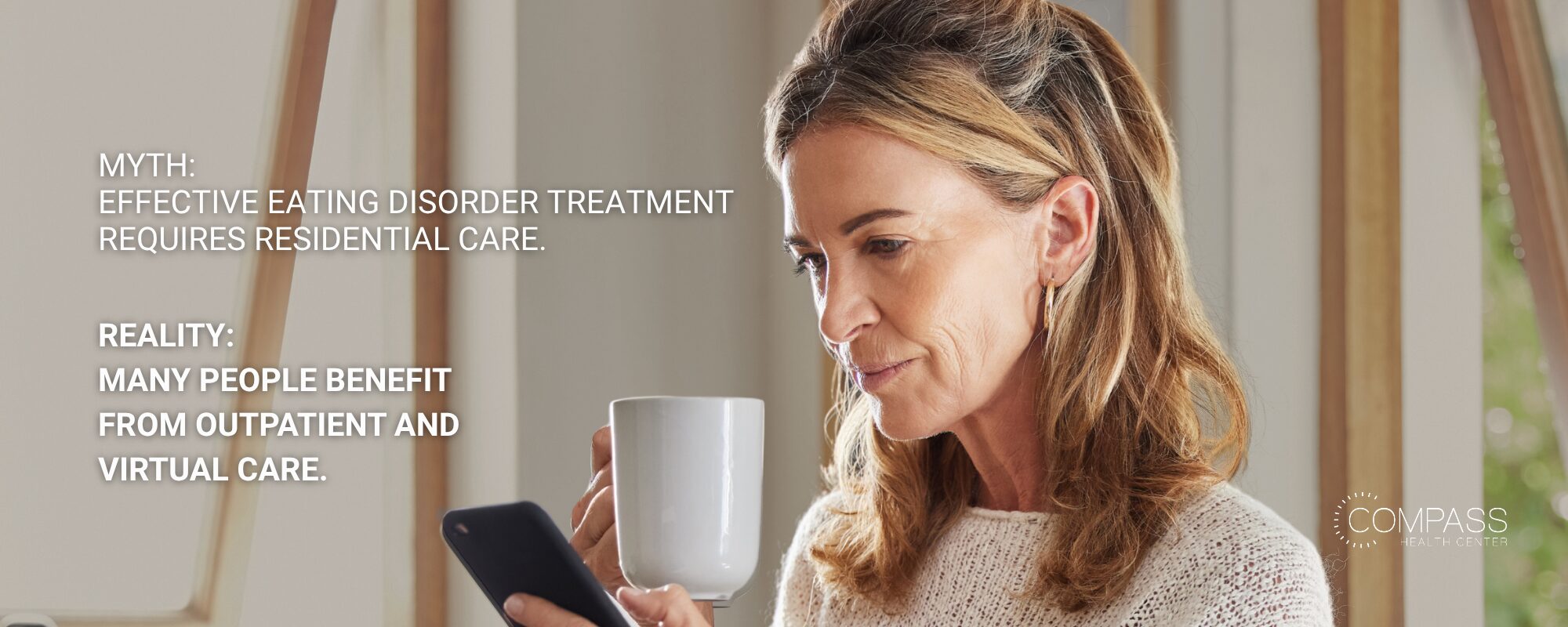 A middle-aged woman holding a white mug and looking at her smartphone. Text reads: “Myth: Effective eating disorder treatment requires residential care. Reality: Many people benefit from outpatient and virtual care.” Compass Health Center logo in the lower right.